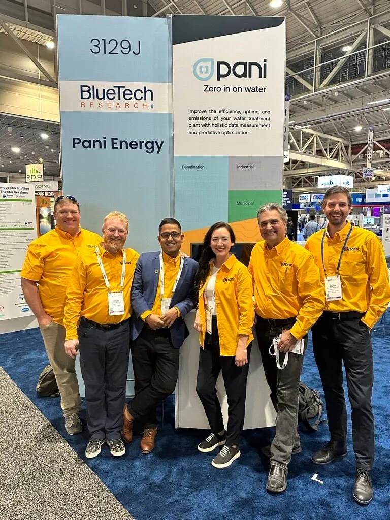 The Pani team in yellow branded shirts at their trade show booth