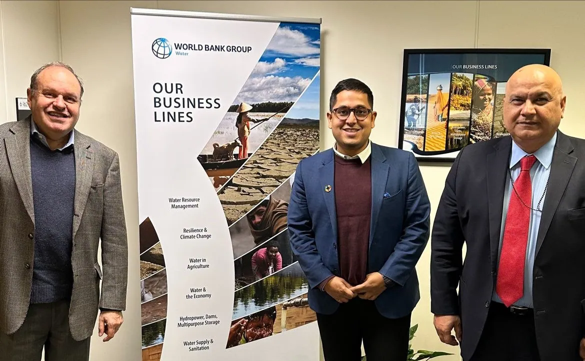 Pani representatives with World Bank Group water team members in front of an 'Our Business Lines' banner