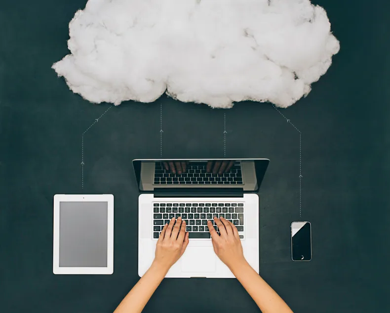 A cloud icon above a tablet, laptop, and mobile phone connected by lines representing data transfer to the cloud for computing