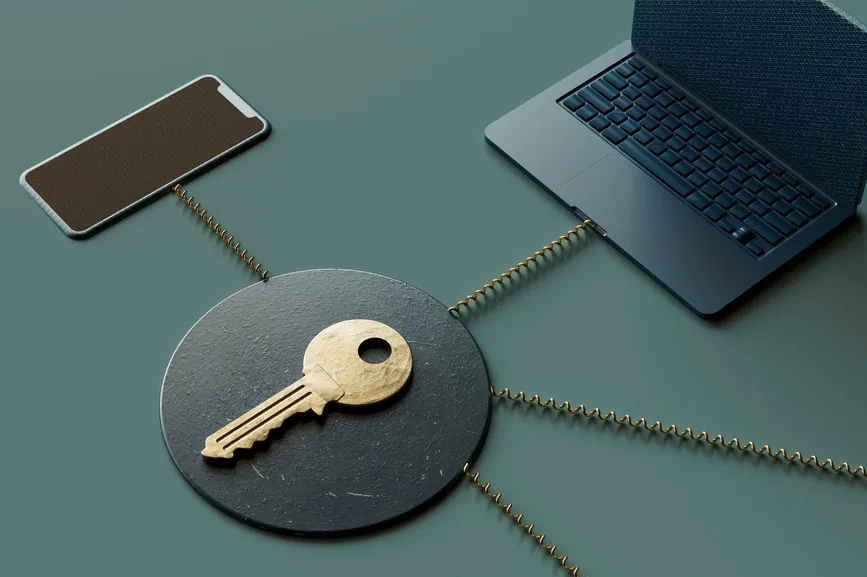 A mobile phone and laptop connected to a key at the center of the image via lines representing cybersecurity