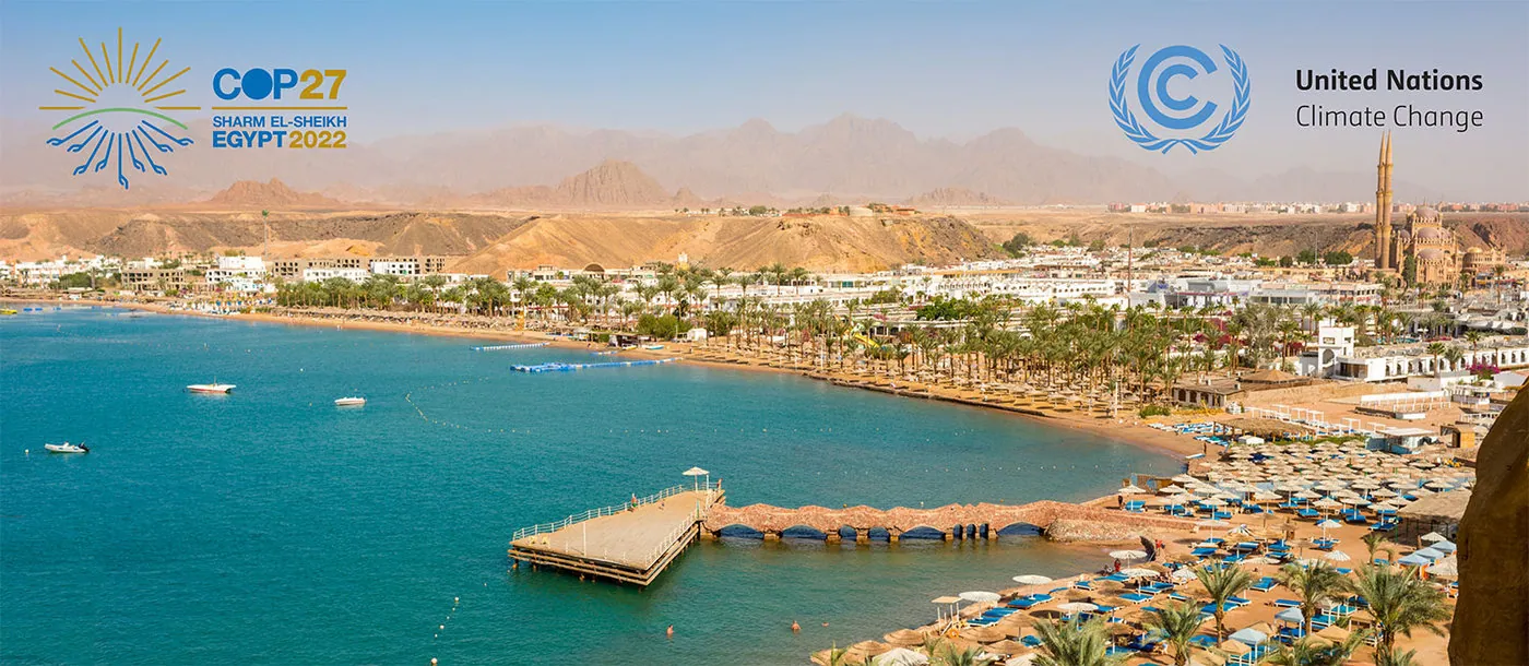 Aerial image of Sharm el-Sheikh, Egypt, with the COP27 and United Nations' Climate Change logos in the top left and right corners